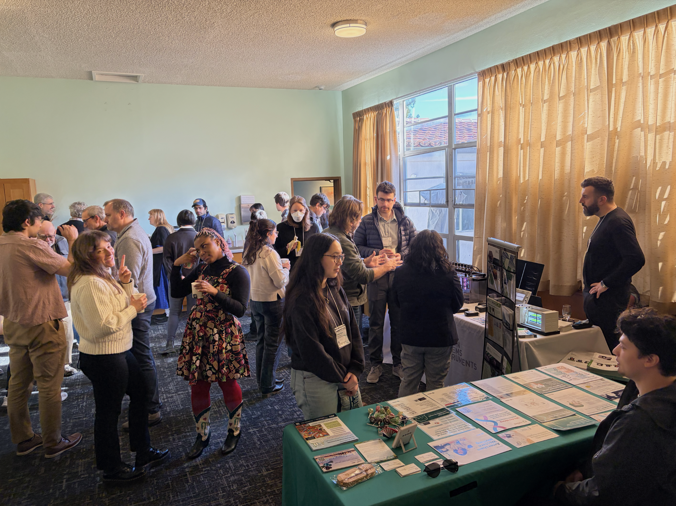 Attendees interacting with sponsors during the coffee break.